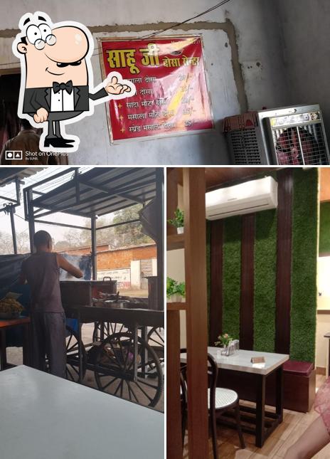 Take a seat at one of the tables at SahuJi's - Dosa Cafe