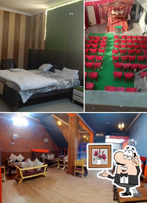 Take a seat at one of the tables at POP Star Hotel And Restaurant