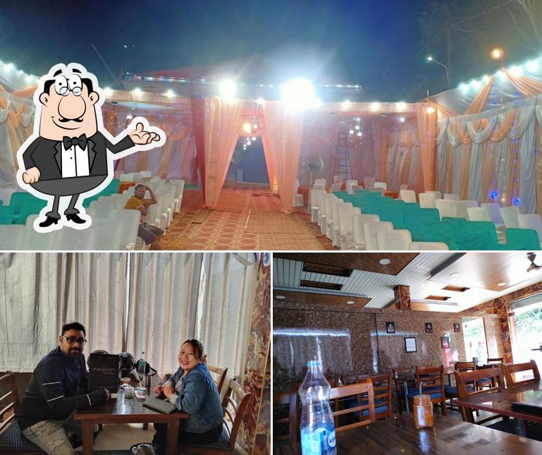 Take a seat at one of the tables at Manglam Restaurant