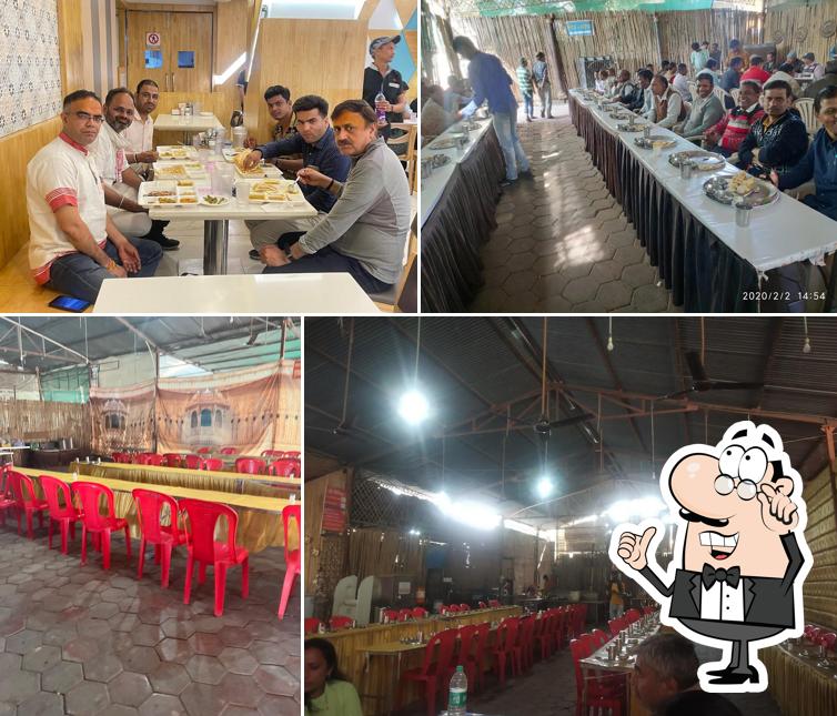 Take a seat at one of the tables at Shree Govindam Restaurant