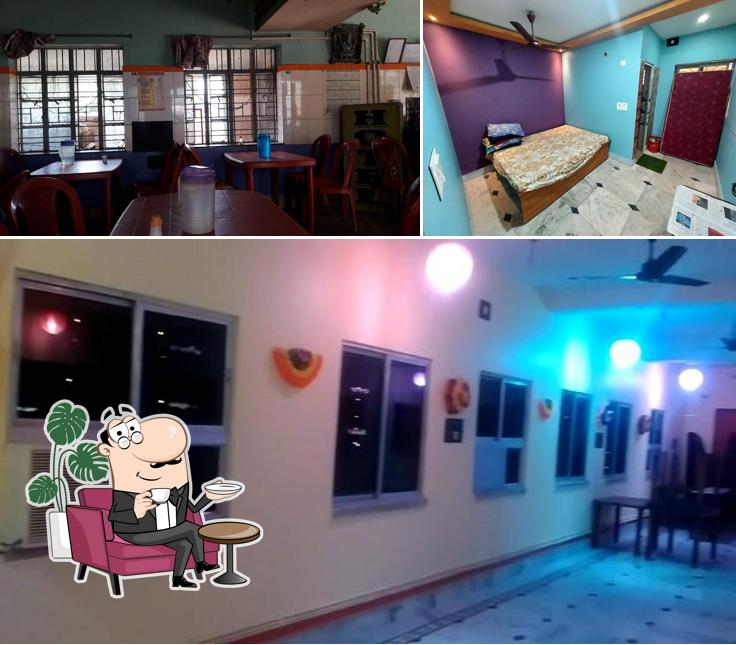 Take a seat at one of the tables at Baba Ashutosh Hindu Hotel And Restaurant