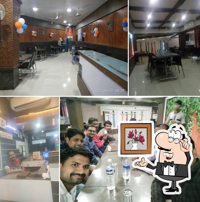 Take a seat at one of the tables at Saffron Veg Restaurant