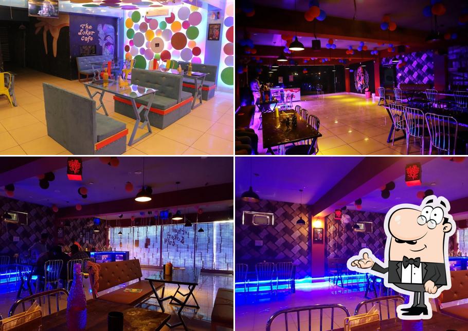 Take a seat at one of the tables at The Joker Cafe & Rooftop Restaurant