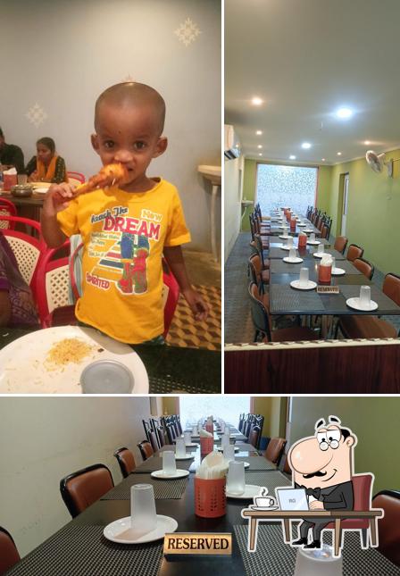 The photo of ANJANEYA GRAND FAMILY RESTARANT’s interior and dining table