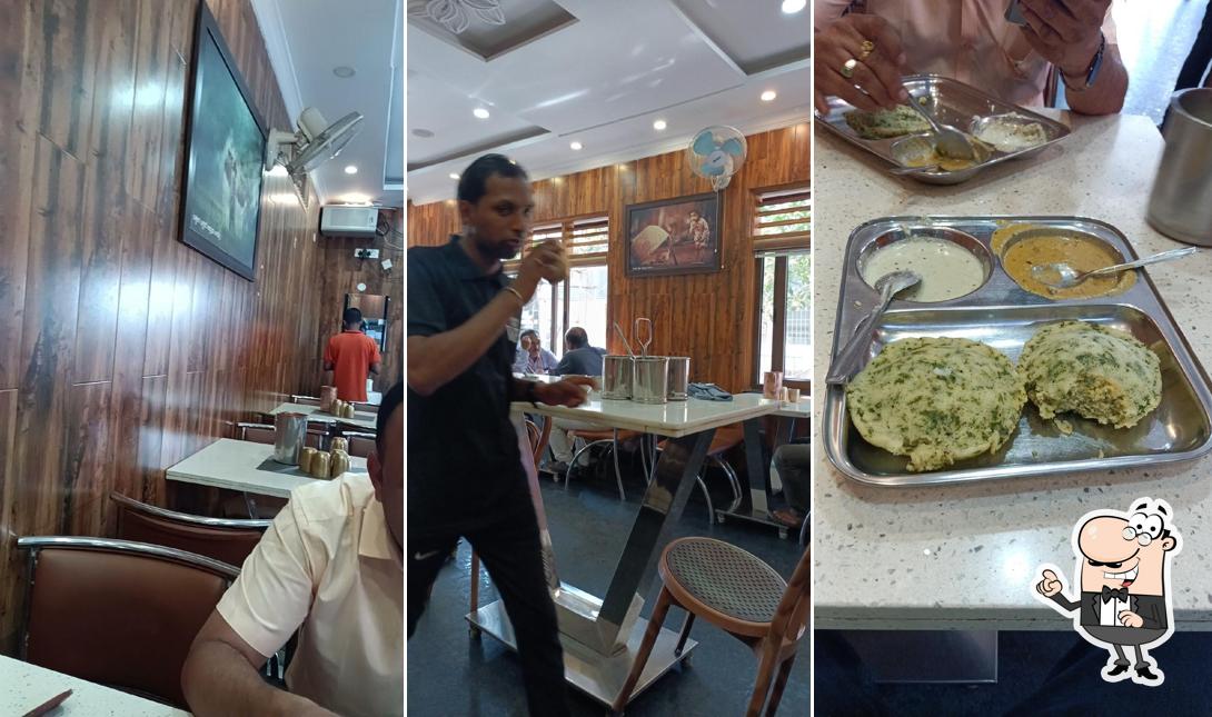 Take a seat at one of the tables at Vidhathri Cafe Jayanagar Shivamogga