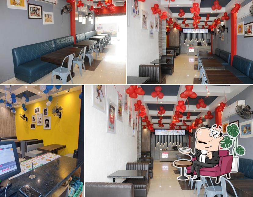 Take a seat at one of the tables at Burger Bar - Best Pizza, Burger, Veg And Non Veg Restaurant, Family Restaurant, Coffee Cafe