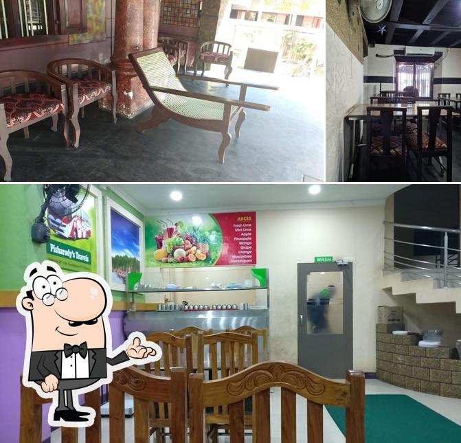 Take a seat at one of the tables at Pisharody's Restaurant(Pure Veg)
