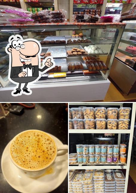 Take a look at the picture displaying interior and drink at Navya Bake Shop, Karukutty