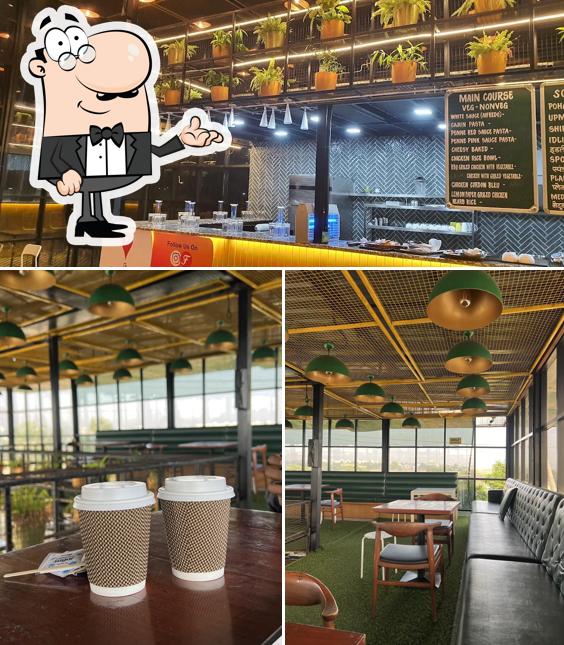 Take a seat at one of the tables at Food Station (The Best Restaurant)