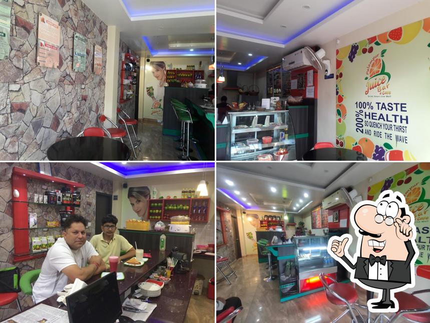 Take a seat at one of the tables at Palampur Juice Bar & Cafe