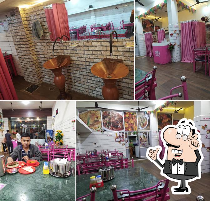 Take a seat at one of the tables at The J D Restaurant - Rajkot