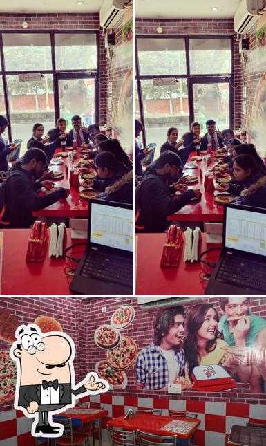 Take a seat at one of the tables at Pizza Hub