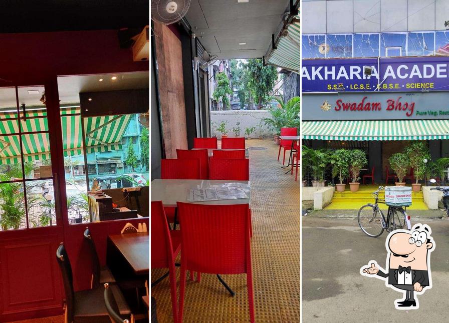 Take a seat at one of the tables at Swadam Bhog Pure Veg Restaurant