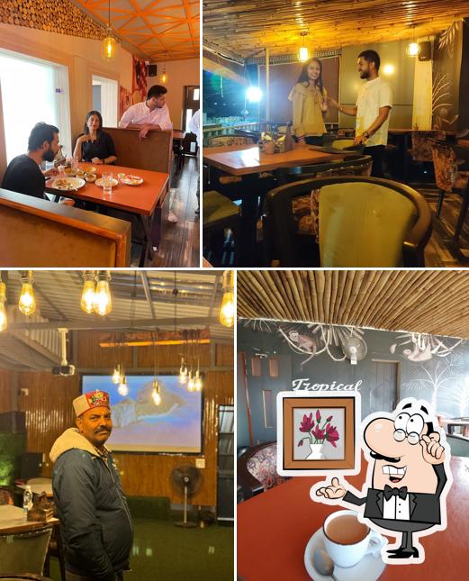 Take a seat at one of the tables at Khatirdari Restaurant Baijnath (Pure Vegetarian)