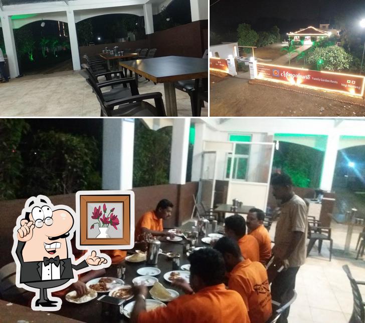 Take a seat at one of the tables at Mangalmurti Resto