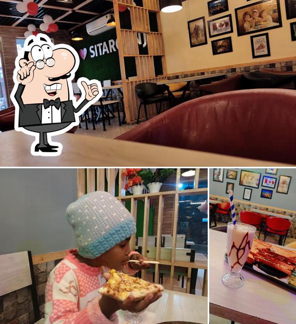 Take a seat at one of the tables at ZAPIZZA Sitarganj