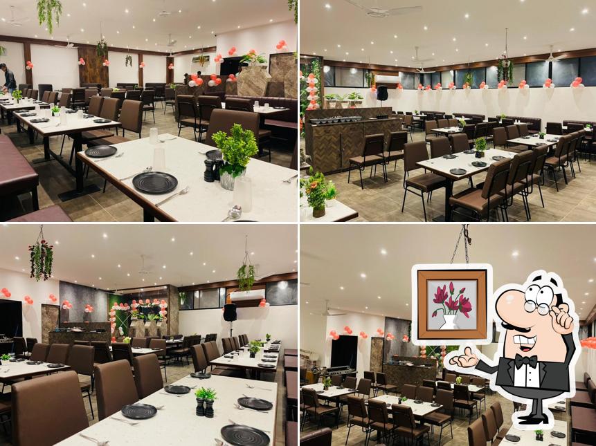 Take a seat at one of the tables at Shreeleela Restaurant Bengali Square