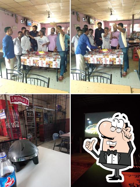 Take a seat at one of the tables at Kanakadurga Bar and Restaurant