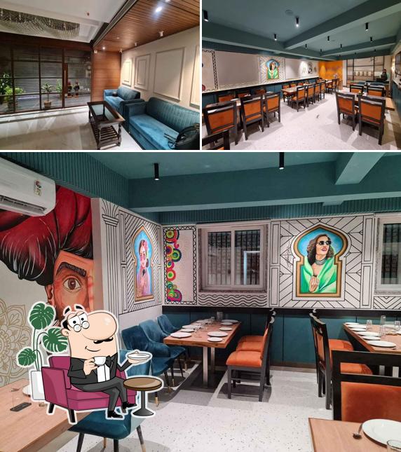 Take a seat at one of the tables at Pakwan - Pure Veg Family Restaurant