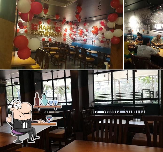 Take a seat at one of the tables at AASWAD MULTI CUISINE