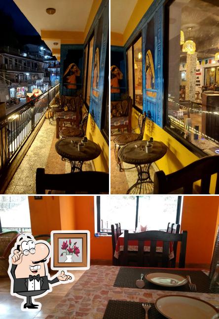 Take a seat at one of the tables at Darjeeling Cafe&Stay