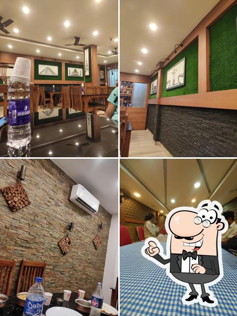 Take a seat at one of the tables at Spicy villa family Restaurant