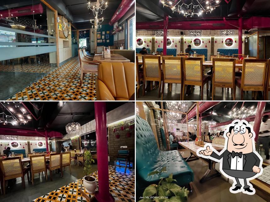 Take a seat at one of the tables at Nini's Kitchen - (V V Nagar)