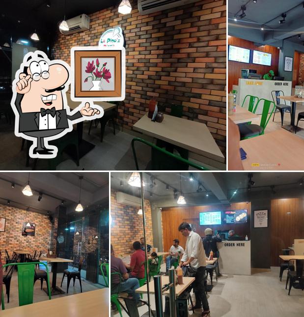 Take a seat at one of the tables at La Pino'z Pizza Bistupur Jamshedpur