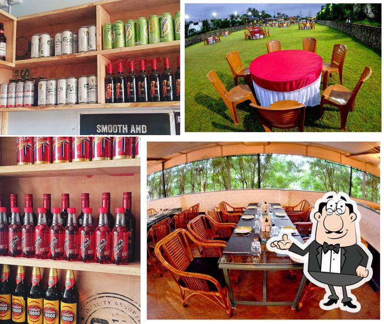 Take a seat at one of the tables at Woodlot Garden Restaurant Padegaon