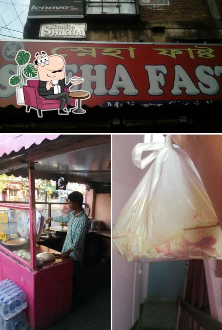 Take a seat at one of the tables at Sneha Fast Food Restaurant