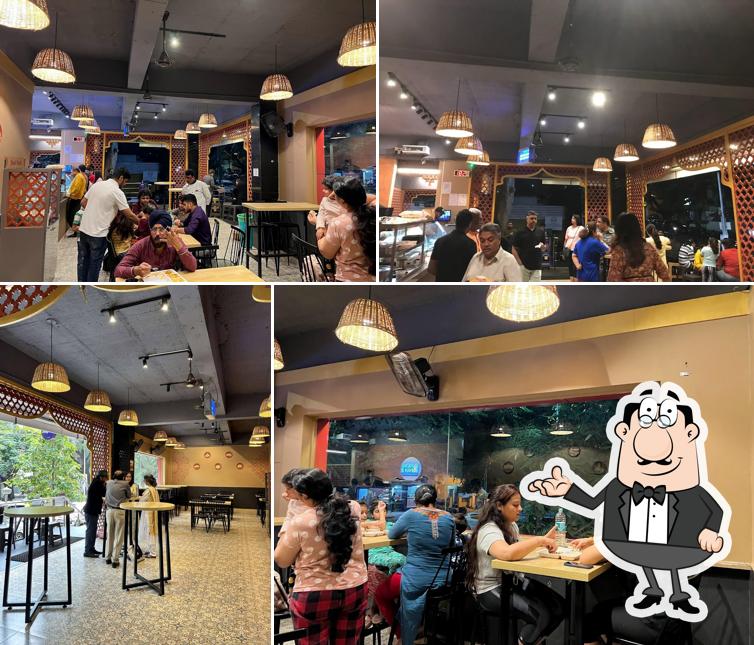 Take a seat at one of the tables at Aamchi Dilli - Jayanagara
