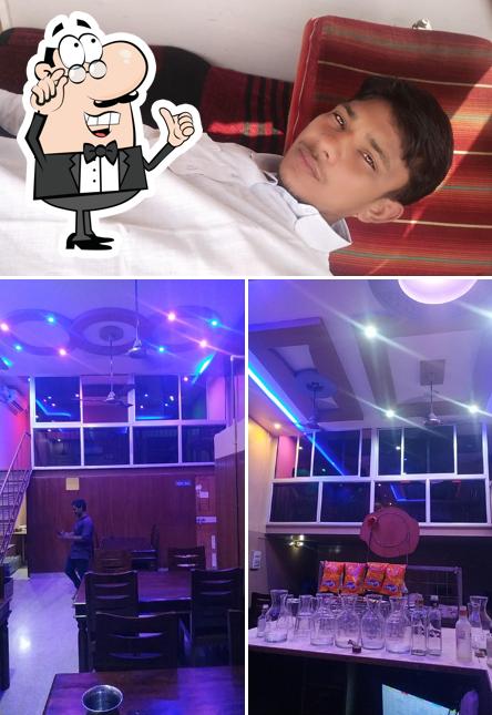 Take a seat at one of the tables at Sangam Bar & Restaurant