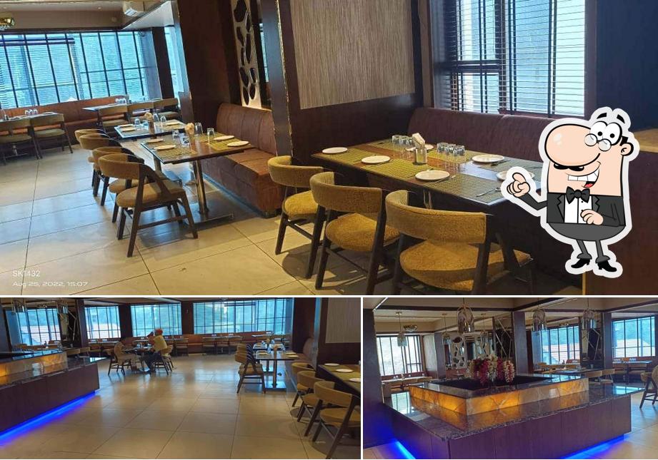 Take a seat at one of the tables at Sai Naivedyam (Restaurant)