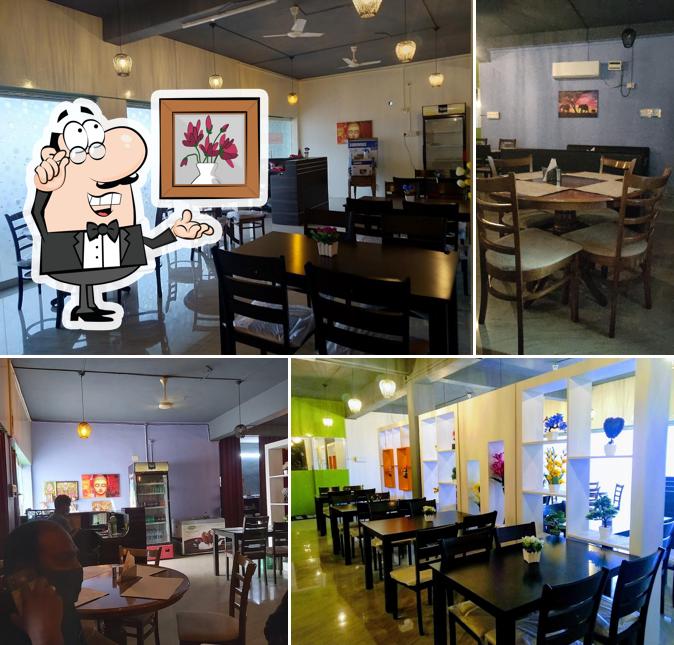 Take a seat at one of the tables at Athidhi Grand Inn Family Restaurant