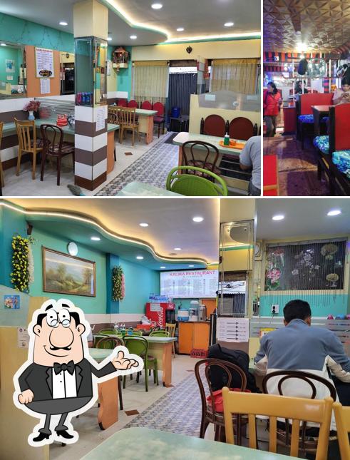 Take a seat at one of the tables at New Kalika Restaurant