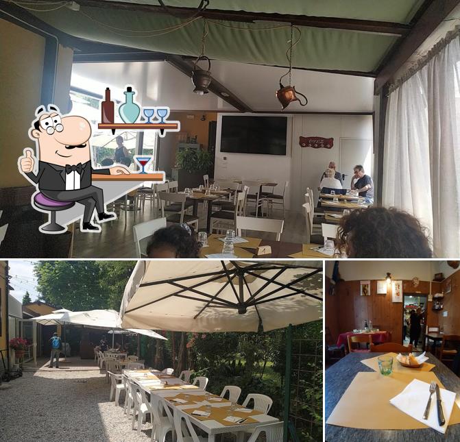 Trattoria Dall’Olio si caratterizza per la interni e tavolo da pranzo