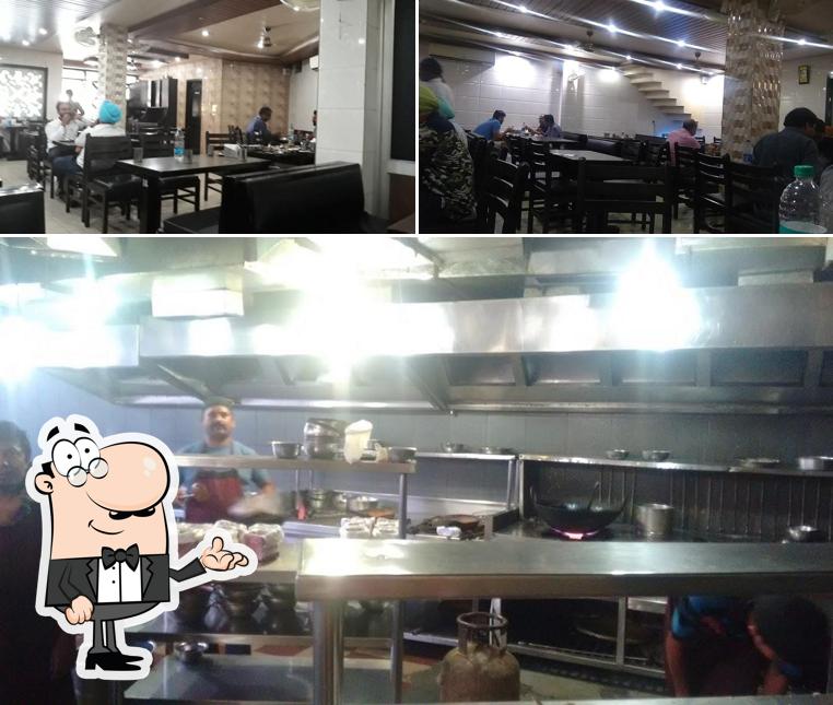 Take a seat at one of the tables at Aman Chicken