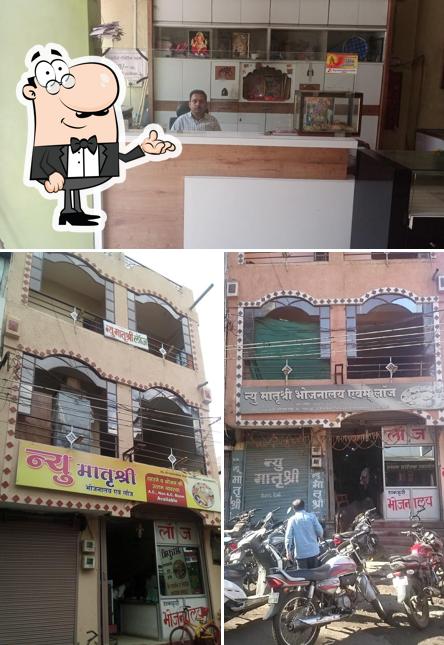 Take a seat at one of the tables at New Matrushree Bhojanalaye and Lodge