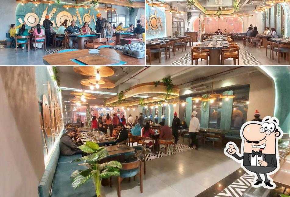Take a seat at one of the tables at Grill kitchen Ultimate BBQ Sindhu Bhavan