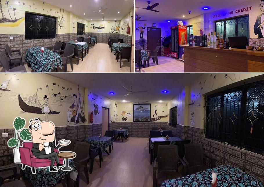 Take a seat at one of the tables at NISARG RESTAURANT & BAR