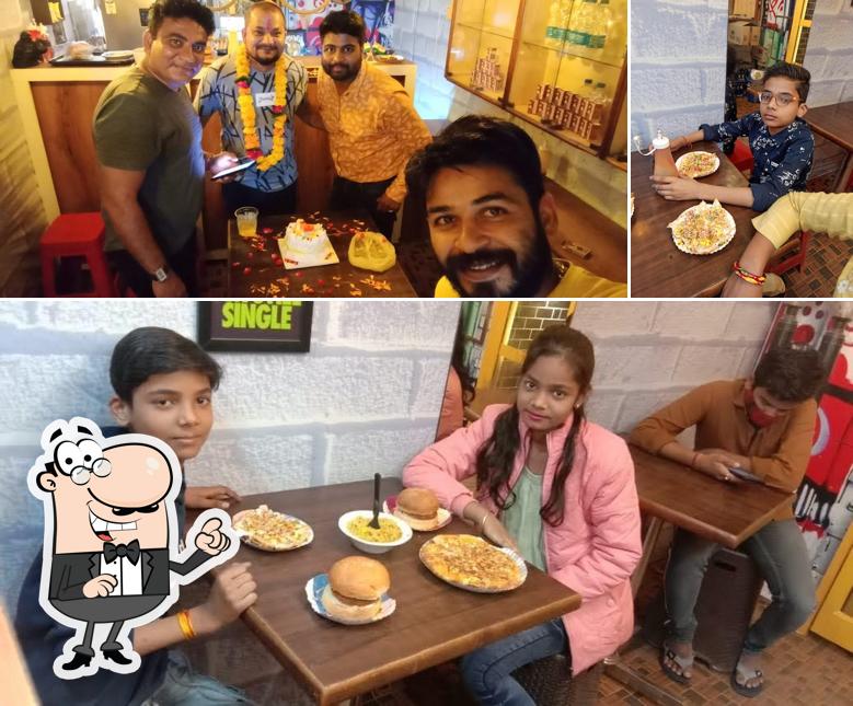 Take a seat at one of the tables at Parivar Cafe Hemu