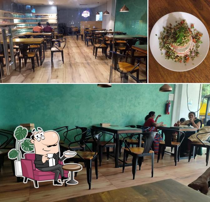 Take a seat at one of the tables at Sattvahaar Cafe