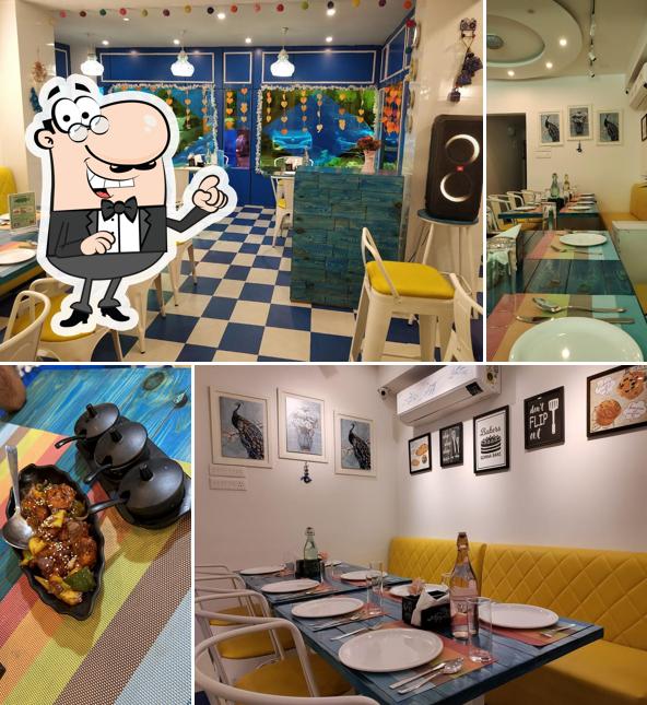 Take a seat at one of the tables at Happy Belly's Mehfil Restaurant ---A Multicuisine Restaurant