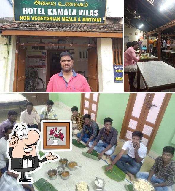 Take a seat at one of the tables at Kamala Vilas Non-Veg Restaurant