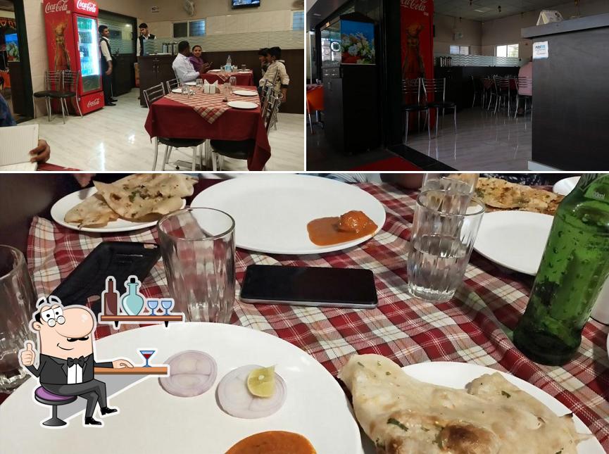 Take a seat at one of the tables at Janvi Restaurant and Lodge