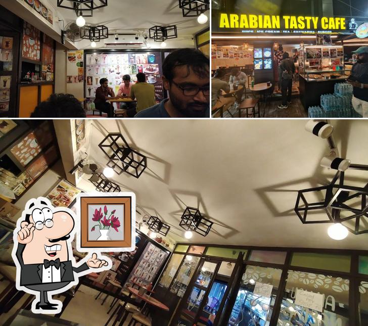 Take a seat at one of the tables at Arabian Tasty Cafe