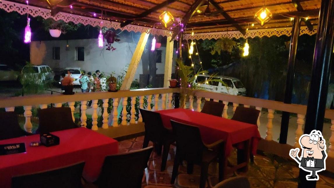 Take a seat at one of the tables at The Back Yard Bar & Kitchen