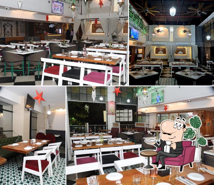 Take a seat at one of the tables at Awadh Restaurant Fc Road