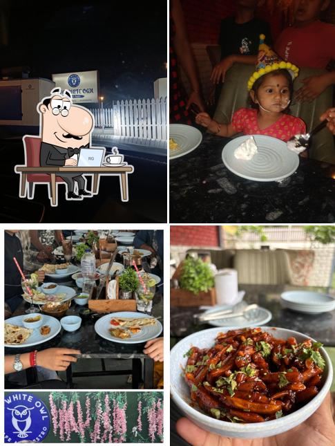 Take a seat at one of the tables at The White Owl Cafe Haldwani