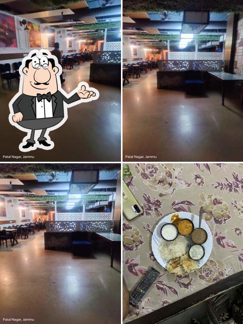 Take a seat at one of the tables at Aroma's Family Restaurant Janipur